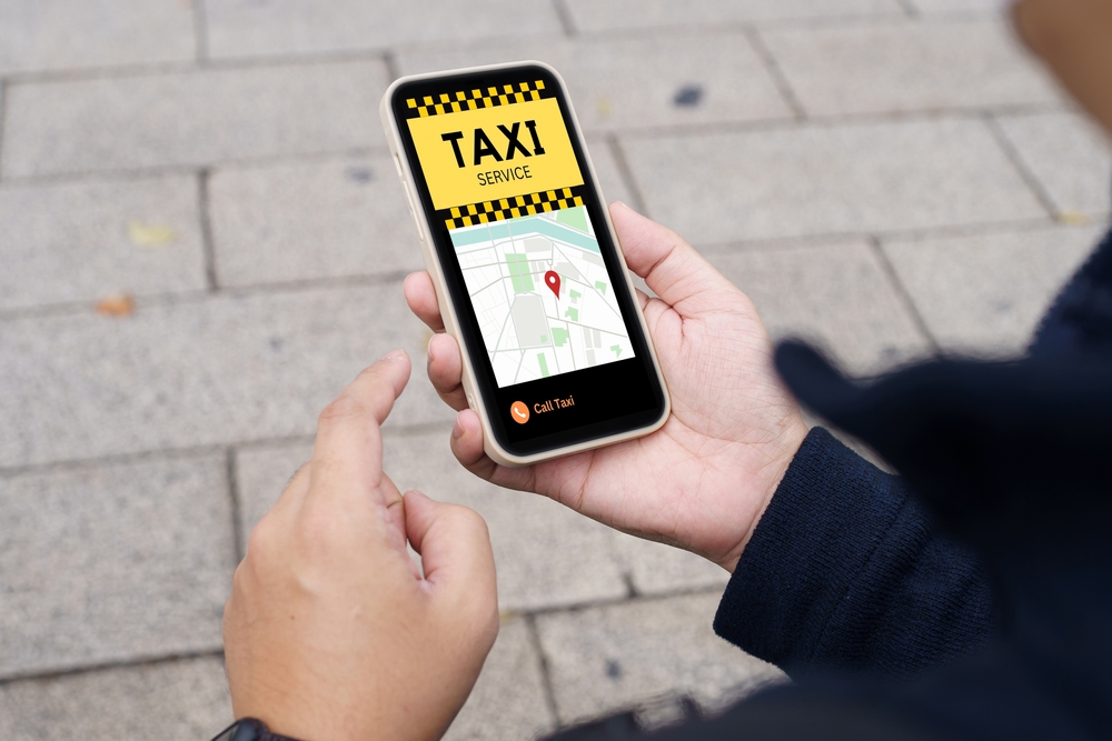 Man,In,Downtown,City,Street,Ordering,Taxi,Using,Smart,Phone